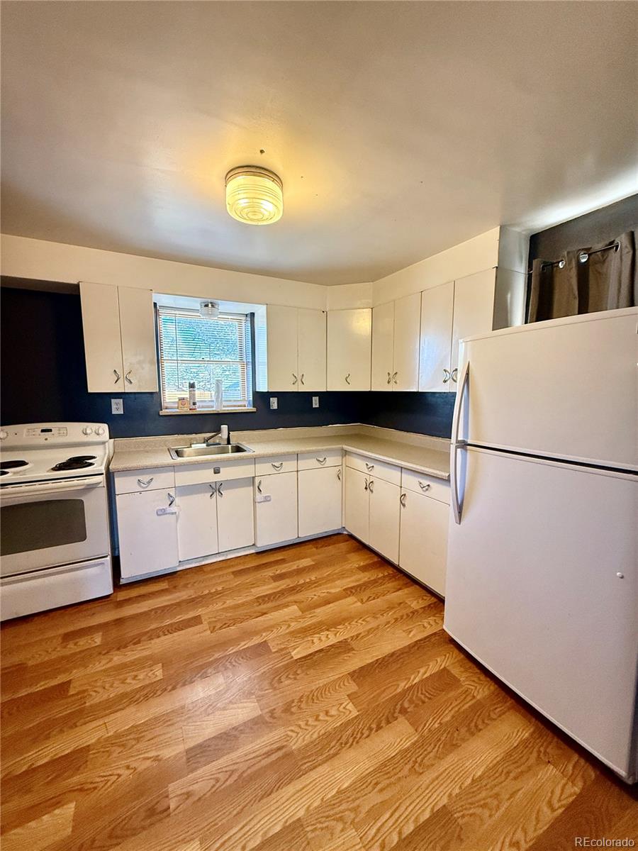 215 Main Street Cheraw, CO 81030 - Photo 9 of 17 a kitchen with granite countertop a sink stainless steel appliances and cabinets