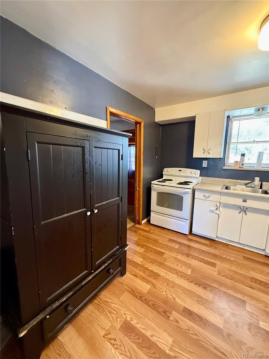 215 Main Street Cheraw, CO 81030 - Photo 10 of 17 a kitchen with a stove and a refrigerator