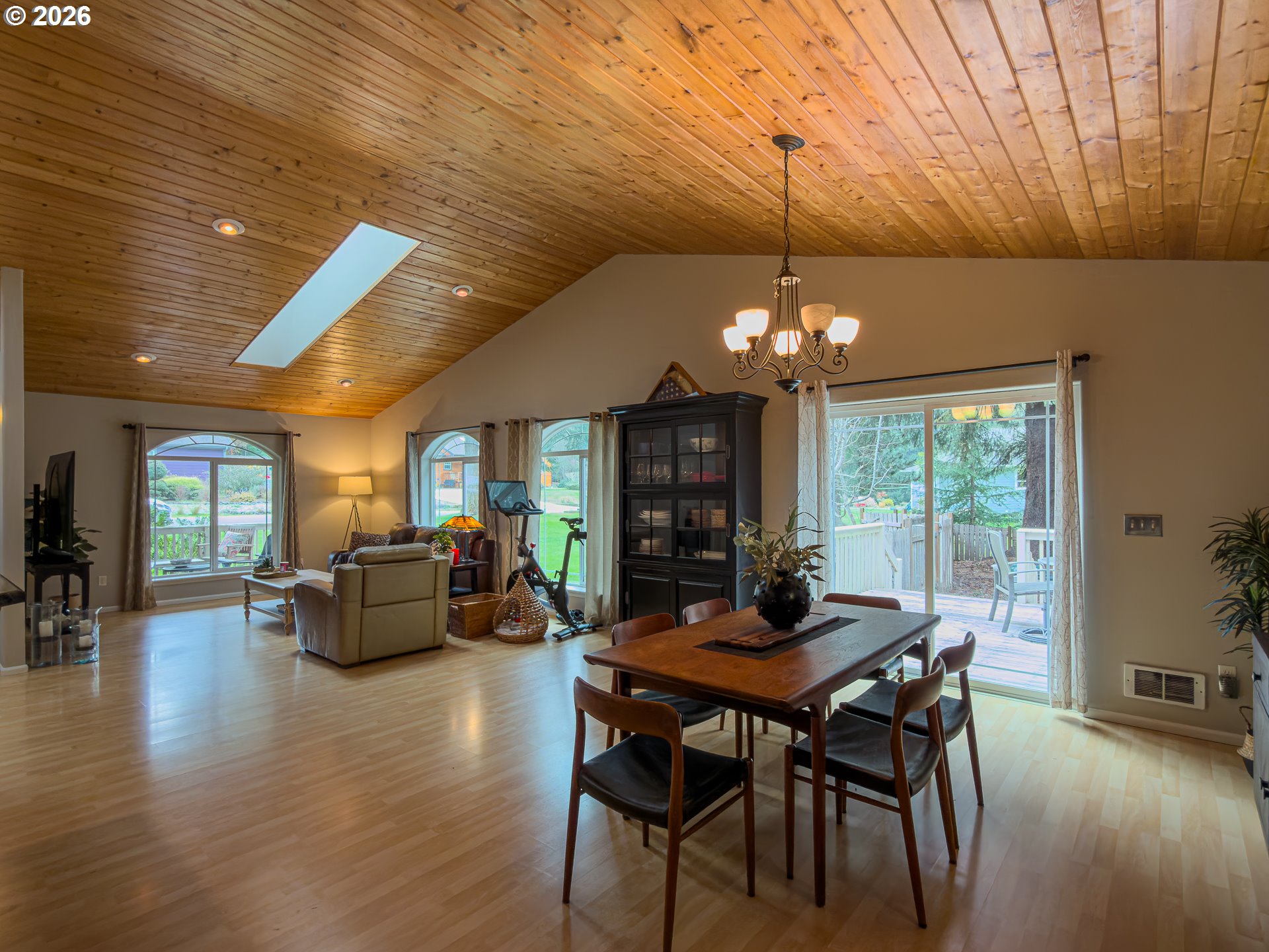 1185 11th Street Southeast Bandon, OR 97411 - Photo 12 of 48 a dining room with furniture a chandelier and wooden floor