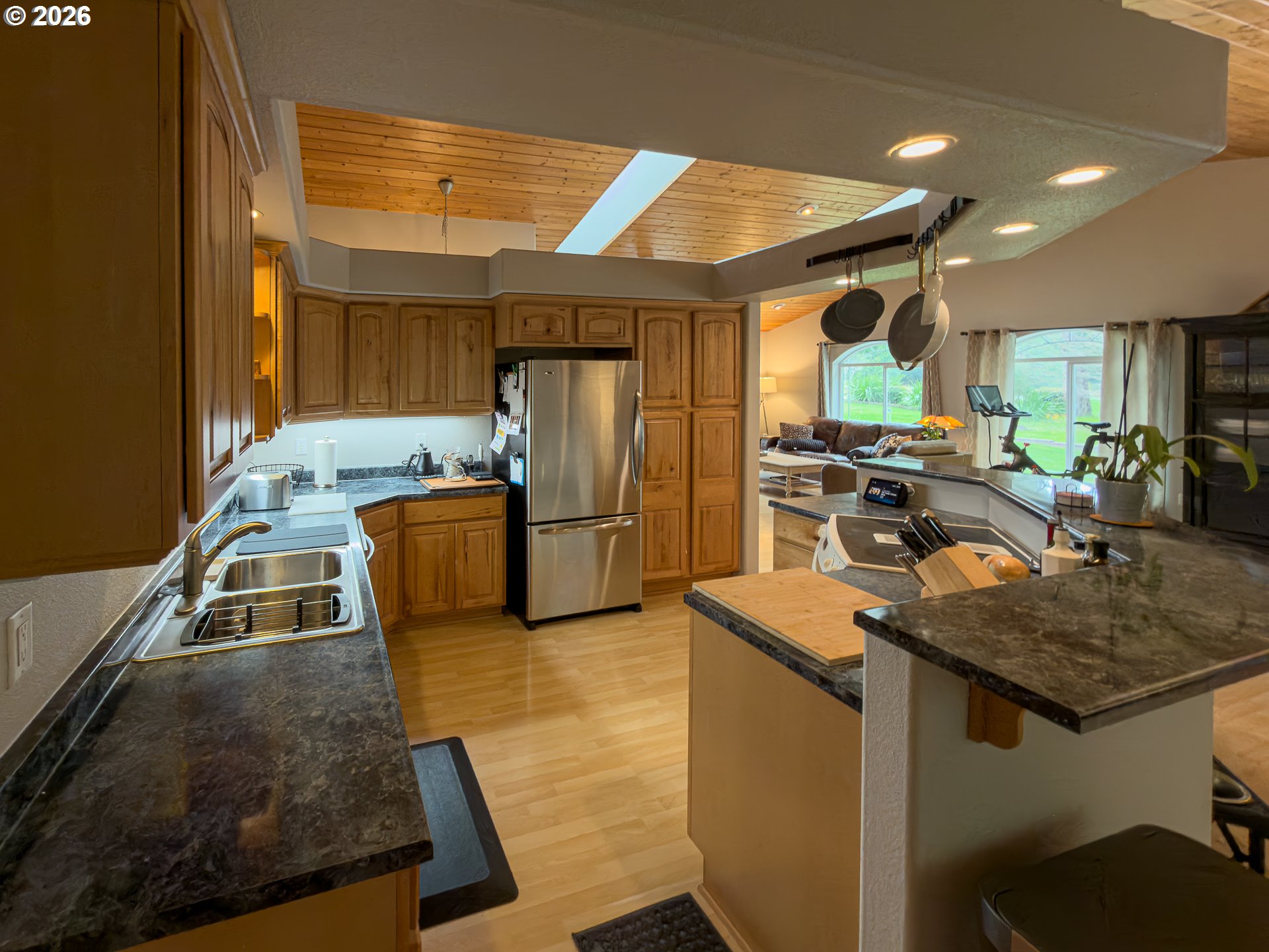 1185 11th Street Southeast Bandon, OR 97411 - Photo 18 of 48 a kitchen with stainless steel appliances granite countertop a sink a stove counter space and a refrigerator
