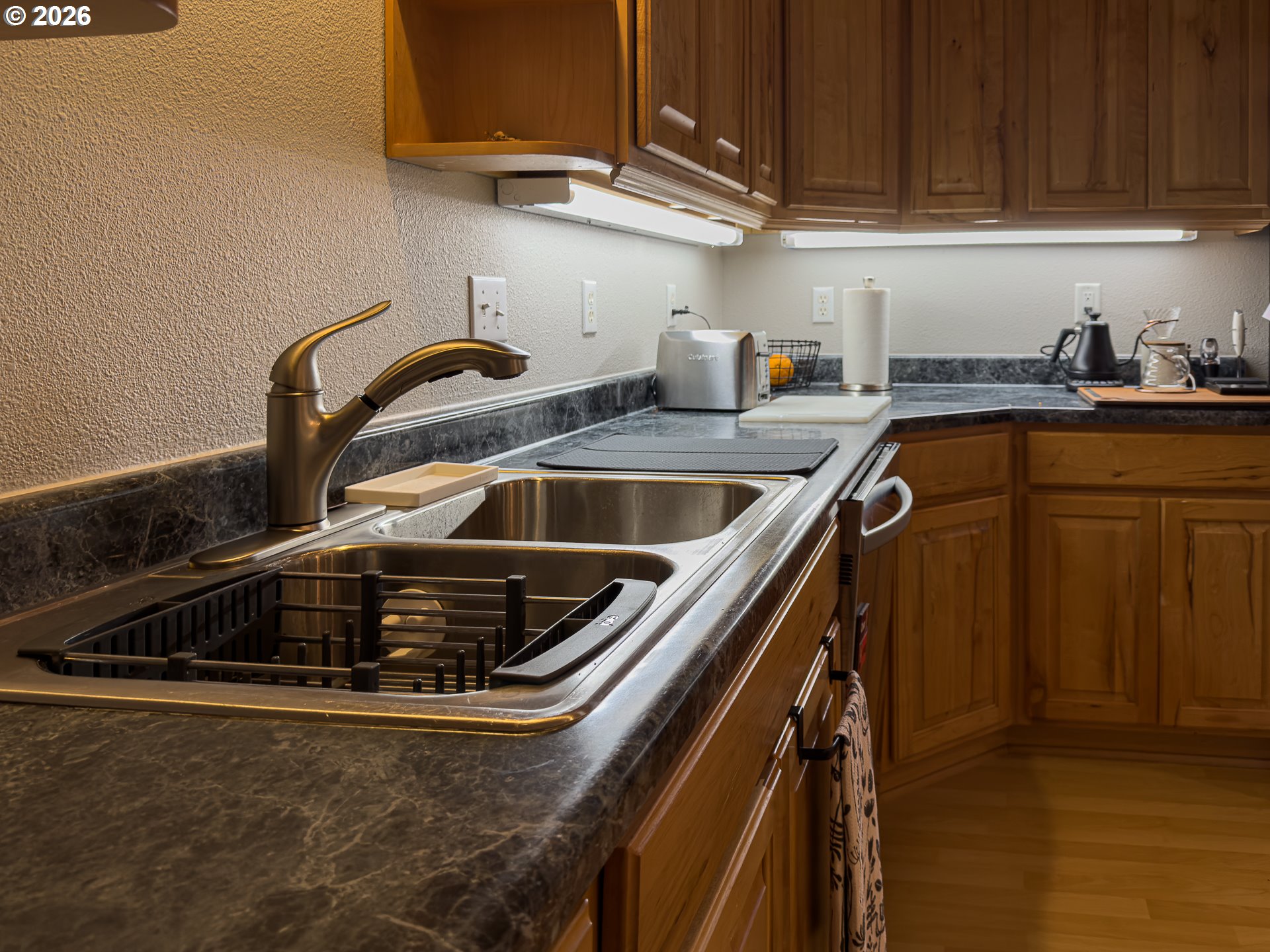 1185 11th Street Southeast Bandon, OR 97411 - Photo 19 of 48 a kitchen with a sink and cabinets