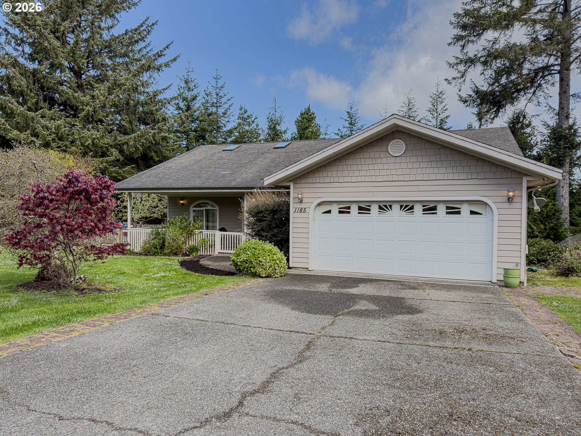 1185 11th Street Southeast Bandon, OR 97411 - Photo 2 of 48 a view of a house with a yard and large tree