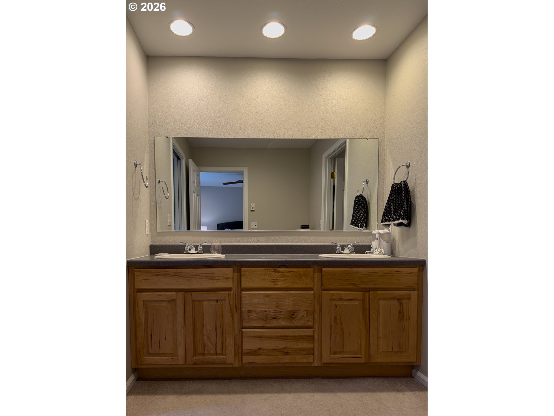 1185 11th Street Southeast Bandon, OR 97411 - Photo 25 of 48 a bathroom with a sink and a mirror