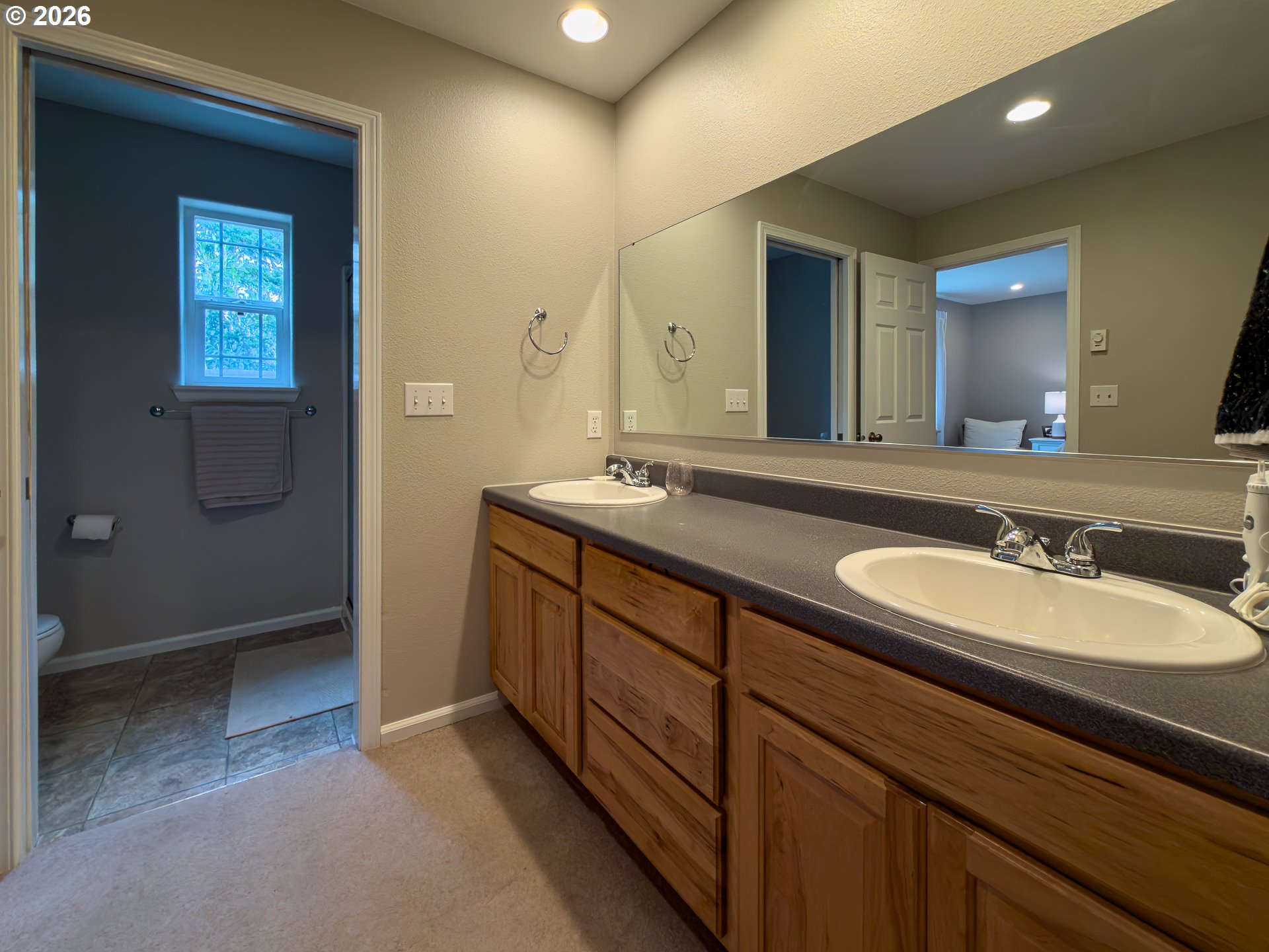 1185 11th Street Southeast Bandon, OR 97411 - Photo 26 of 48 a bathroom with a double vanity sink and a mirror