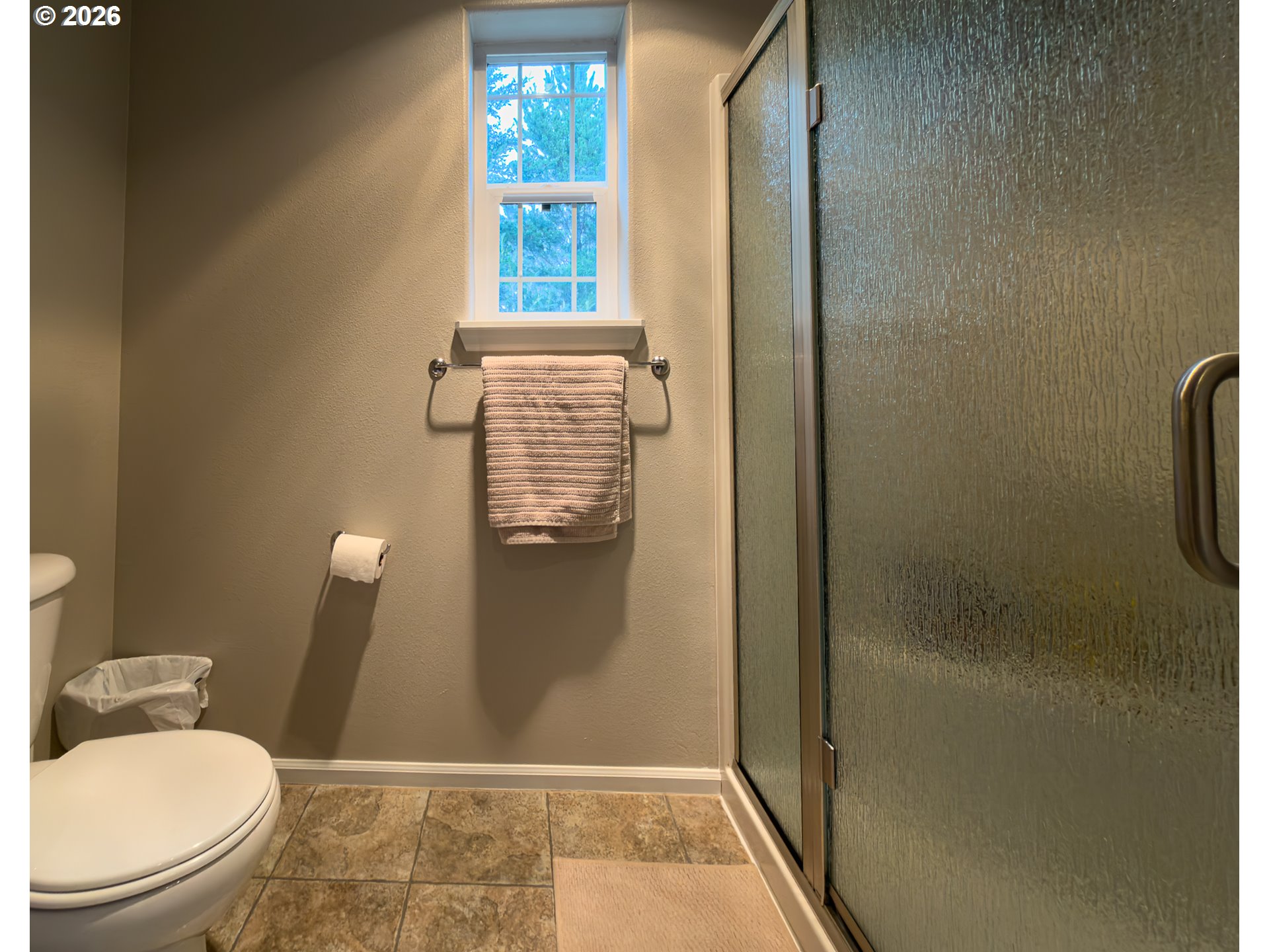 1185 11th Street Southeast Bandon, OR 97411 - Photo 29 of 48 a bathroom with a granite countertop toilet and a shower