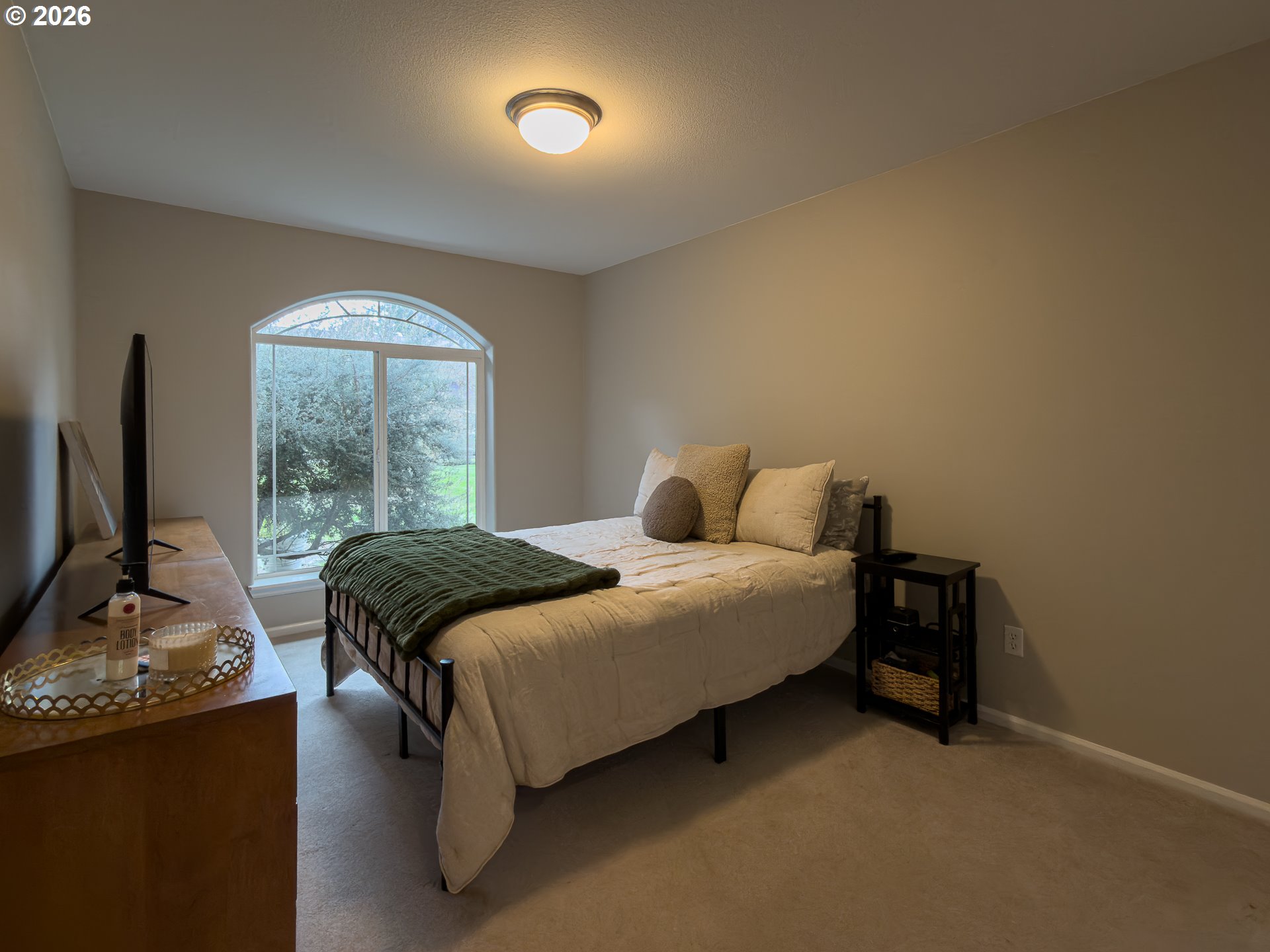 1185 11th Street Southeast Bandon, OR 97411 - Photo 30 of 48 a bedroom with a bed and large windows