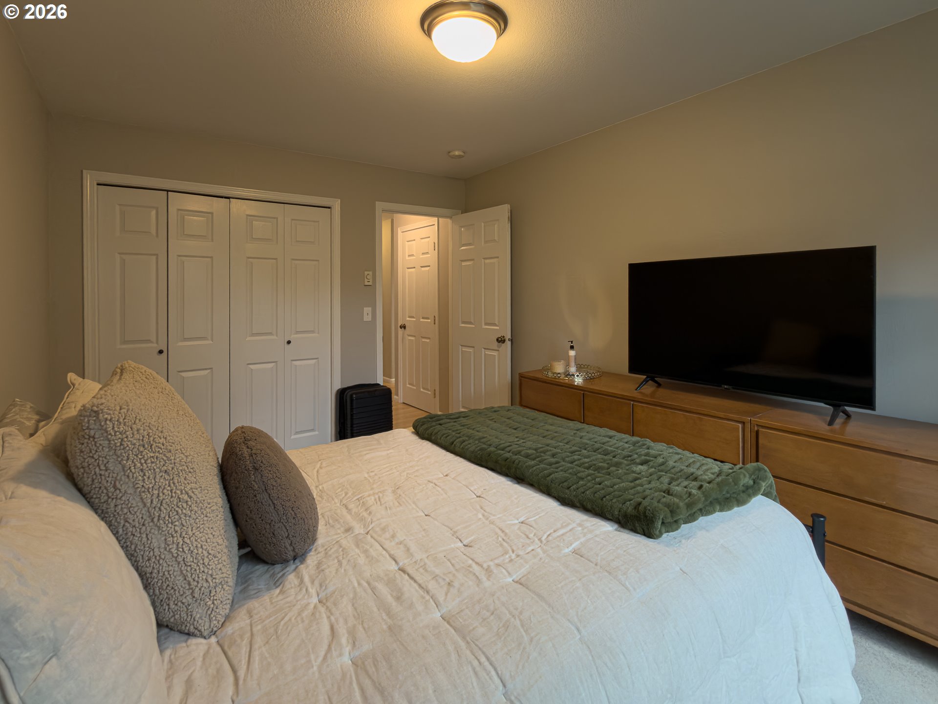 1185 11th Street Southeast Bandon, OR 97411 - Photo 31 of 48 a bedroom with a bed and a flat screen tv