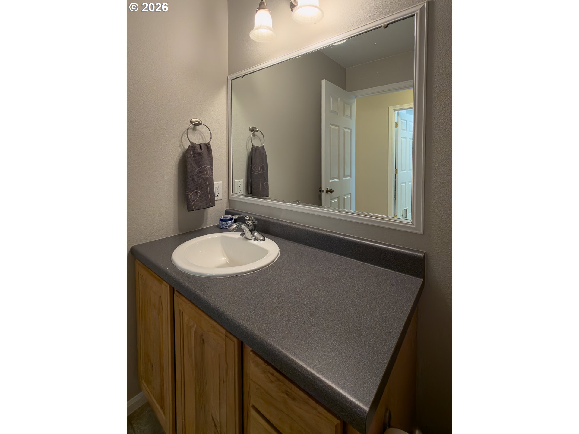 1185 11th Street Southeast Bandon, OR 97411 - Photo 33 of 48 a bathroom with a sink and a mirror