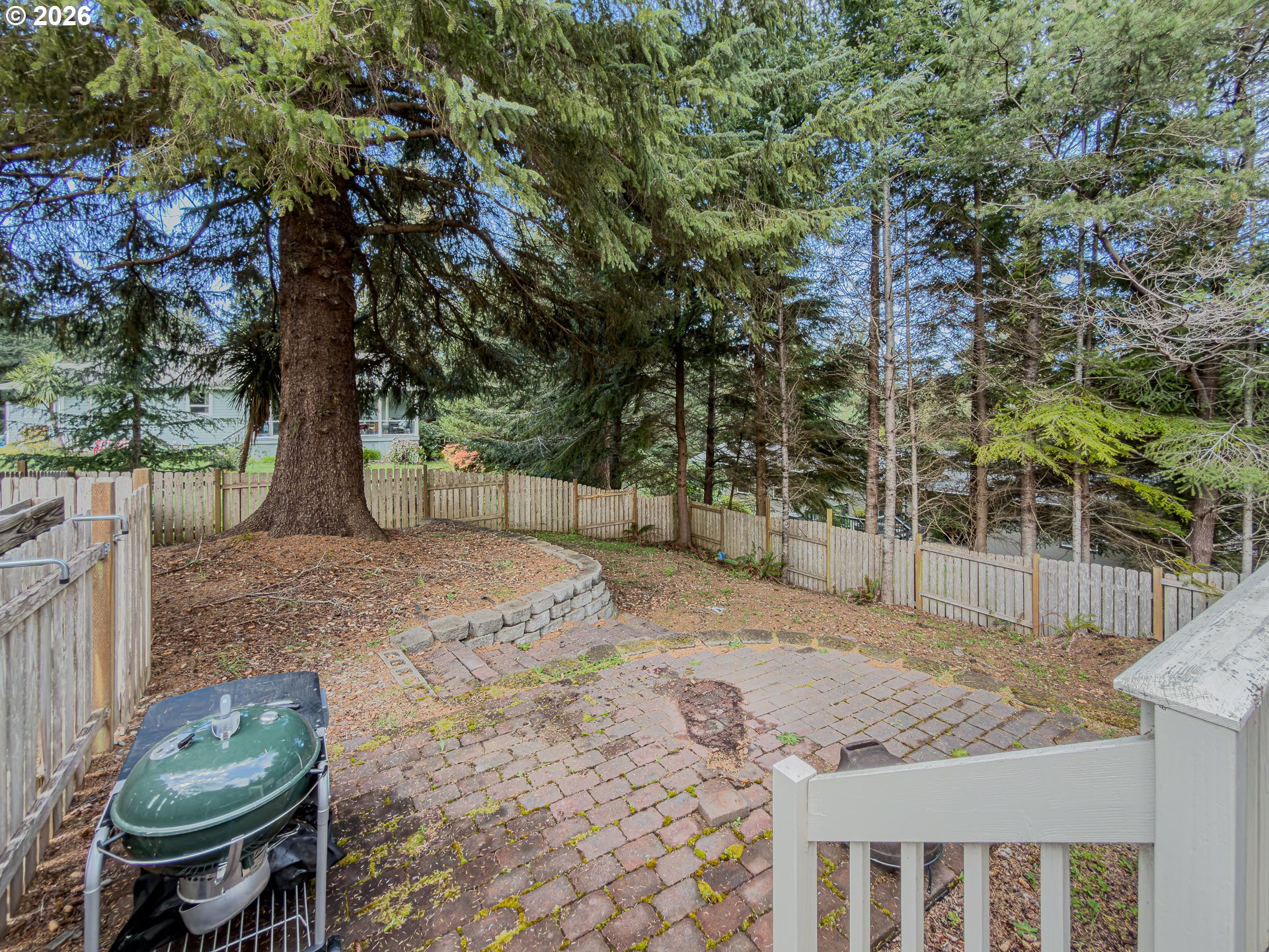 1185 11th Street Southeast Bandon, OR 97411 - Photo 38 of 48 a view of a backyard with iron fence