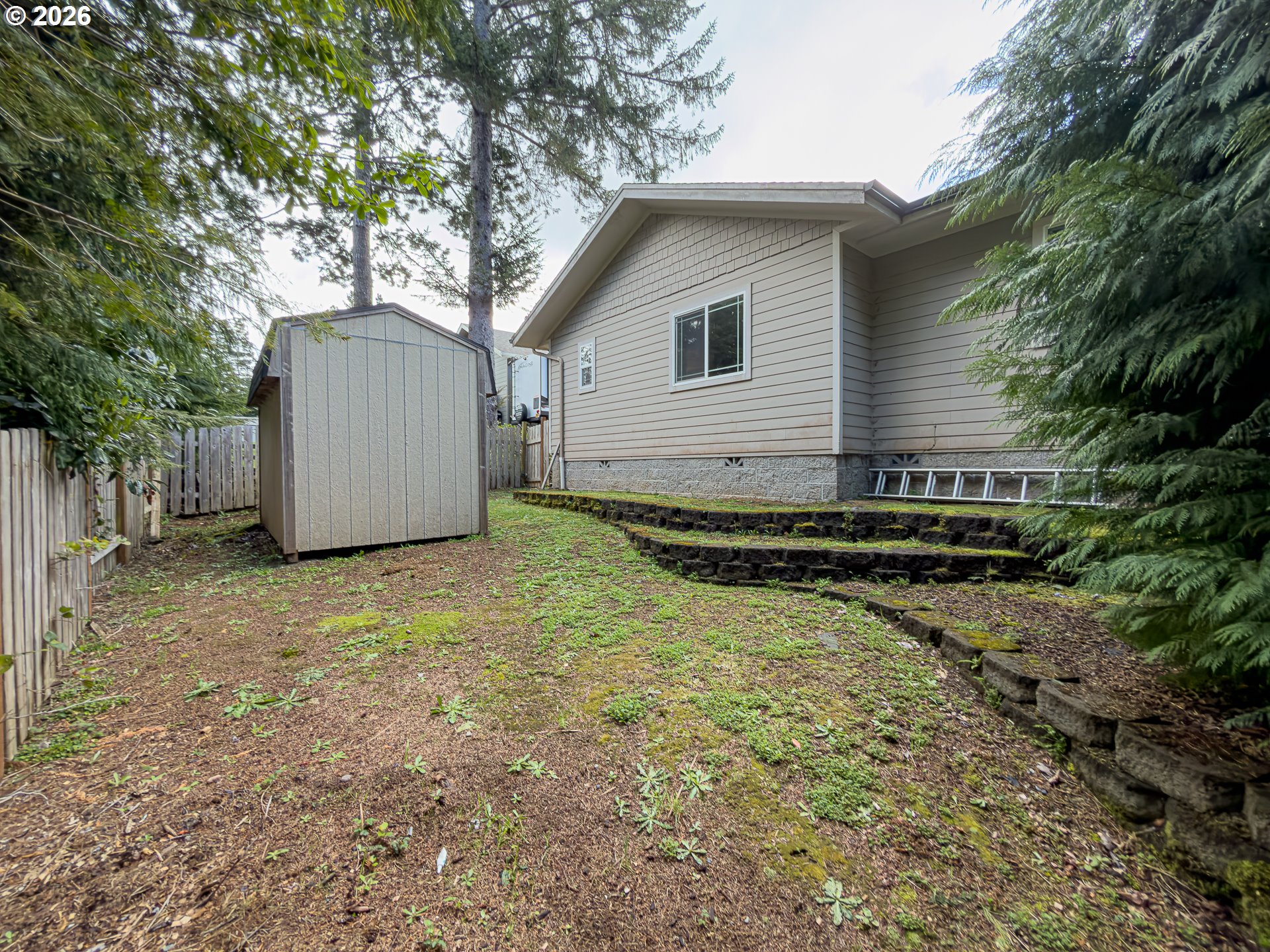 1185 11th Street Southeast Bandon, OR 97411 - Photo 42 of 48 a backyard of a house with barbeque oven table and chairs