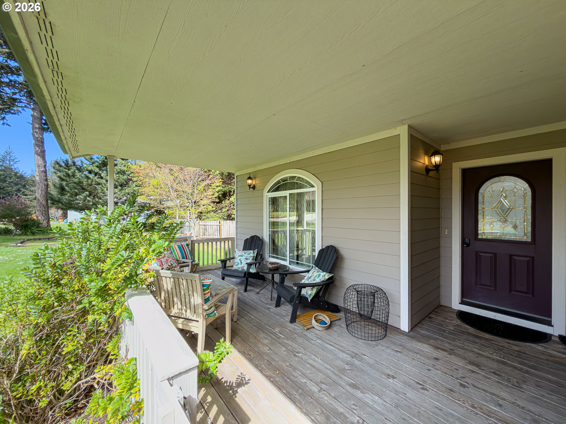 1185 11th Street Southeast Bandon, OR 97411 - Photo 46 of 48 a view of a patio with table and chairs and potted plants