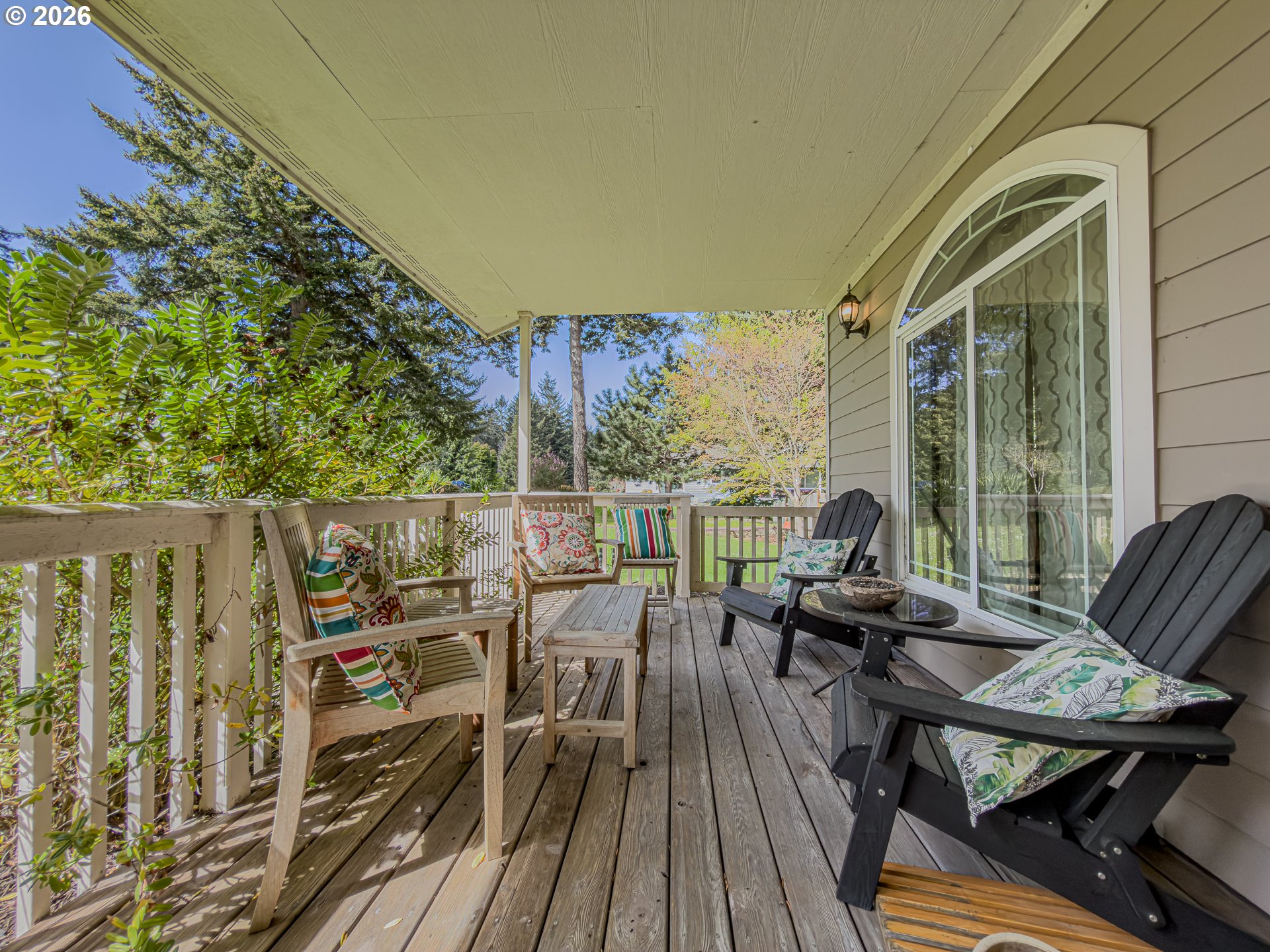 1185 11th Street Southeast Bandon, OR 97411 - Photo 5 of 48 a balcony with wooden floor table and chairs