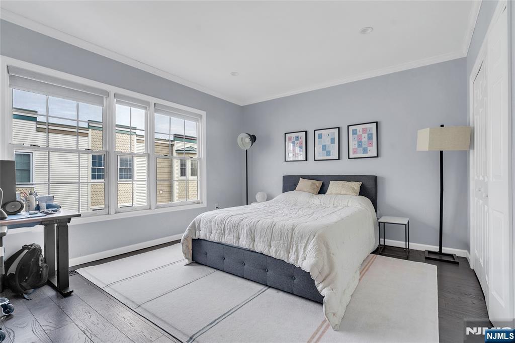 314 The Promenade Edgewater, NJ 07020 - Photo 32 of 37 a bedroom with a bed and a large window