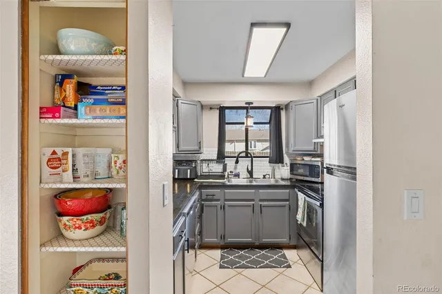 a kitchen with a sink cabinets and appliances