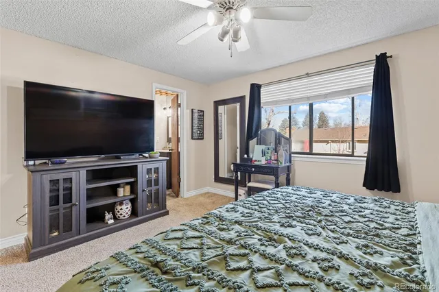 a bedroom with furniture and a flat screen tv