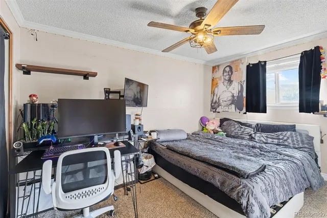 a bedroom with a bed and a chair with the potted plant