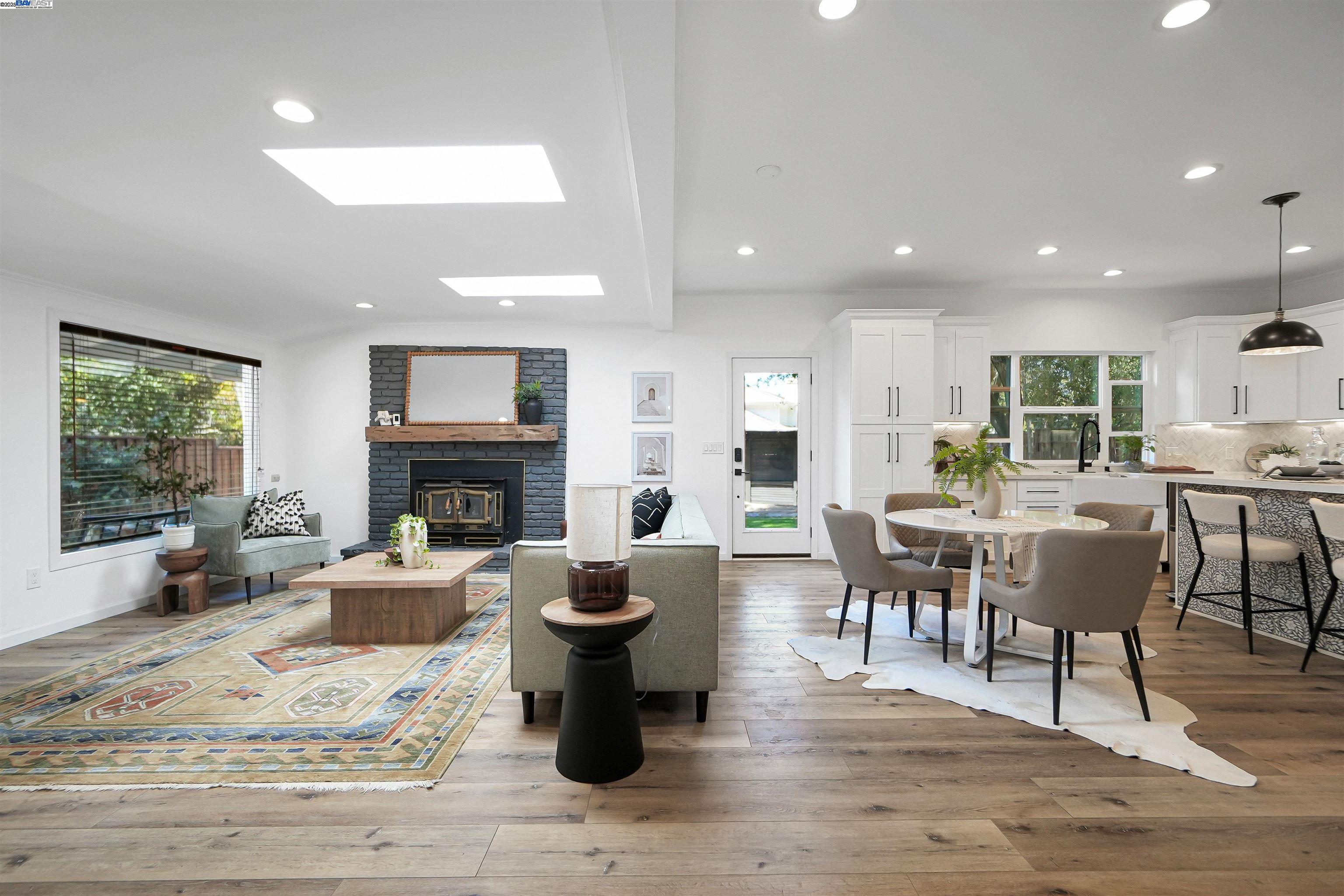 a living room with fireplace furniture and a large window