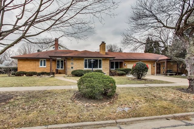 36 South Cowley Road Riverside, IL 60546 - Photo 1 of 42 a front view of a house with a yard