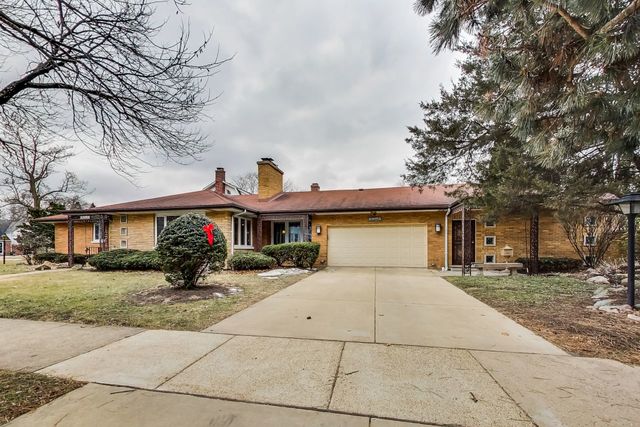 36 South Cowley Road Riverside, IL 60546 - Photo 2 of 42 a front view of a house with a yard and garage