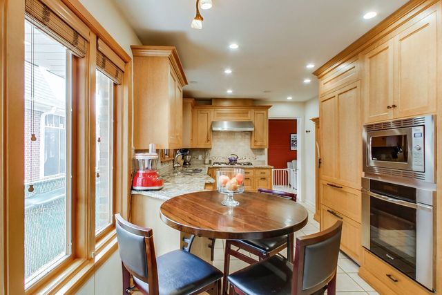 36 South Cowley Road Riverside, IL 60546 - Photo 13 of 42 a kitchen with a table chairs microwave and cabinets