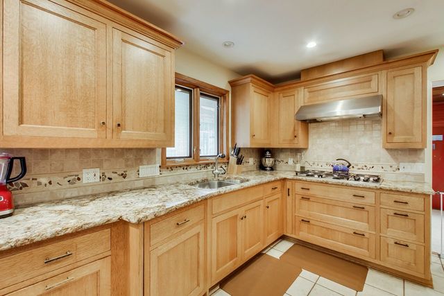 36 South Cowley Road Riverside, IL 60546 - Photo 14 of 42 a kitchen with granite countertop white cabinets and white appliances