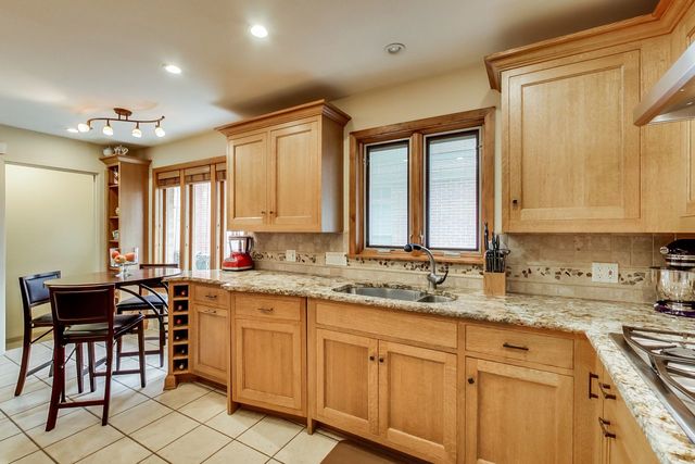 36 South Cowley Road Riverside, IL 60546 - Photo 15 of 42 a kitchen with sink a window and chairs