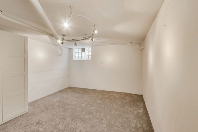 36 South Cowley Road Riverside, IL 60546 - Photo 34 of 42 an empty room with a chandelier fan and windows
