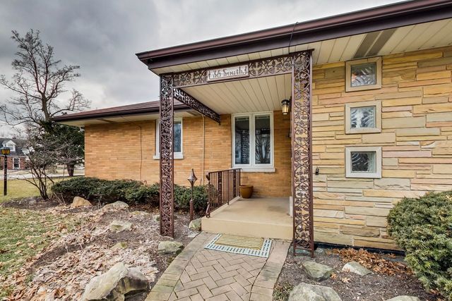 36 South Cowley Road Riverside, IL 60546 - Photo 5 of 42 a front view of a house with garden