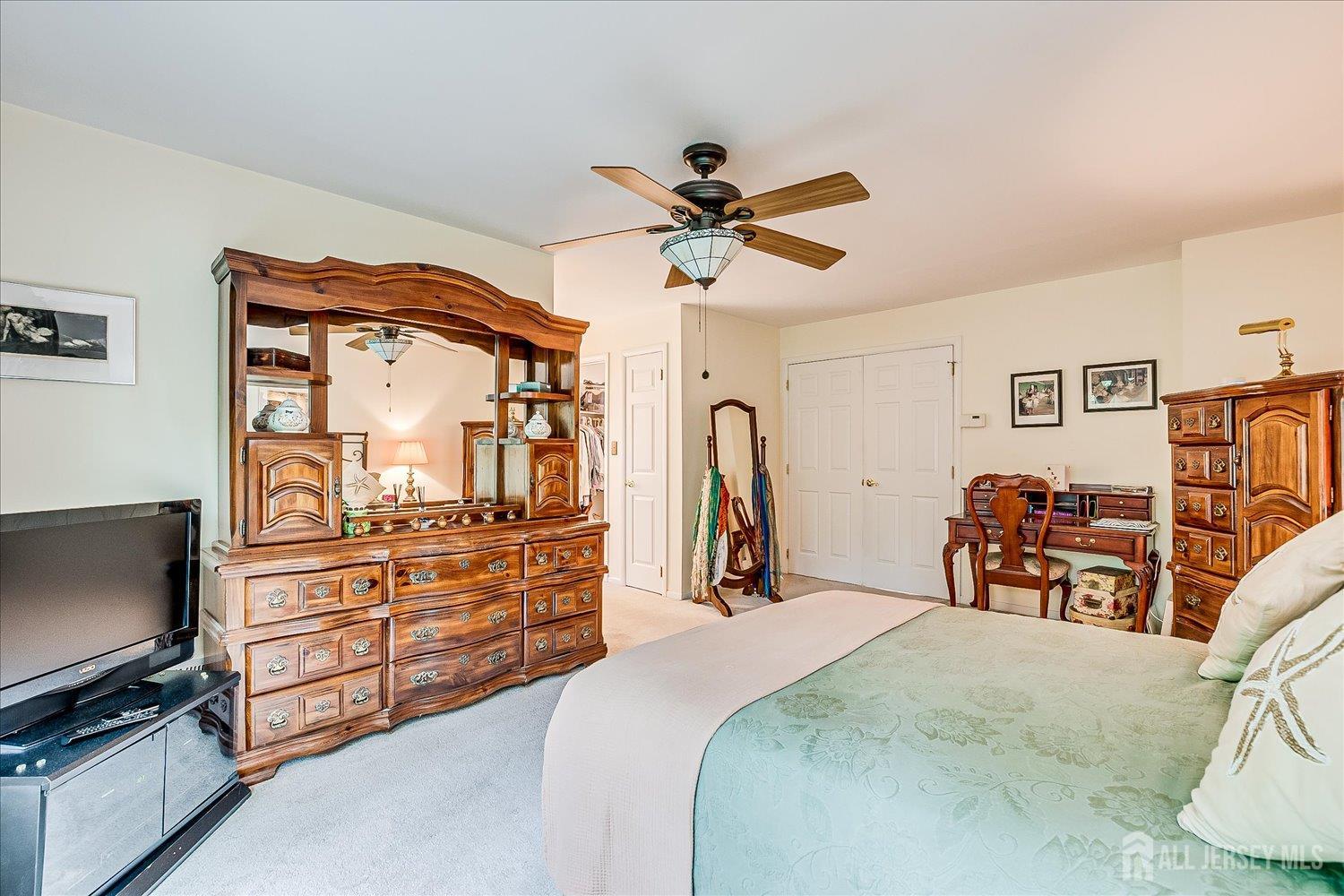 4805 Stonehedge Road Edison, NJ 08820 - Photo 24 of 41 a bed room with a bed and a television
