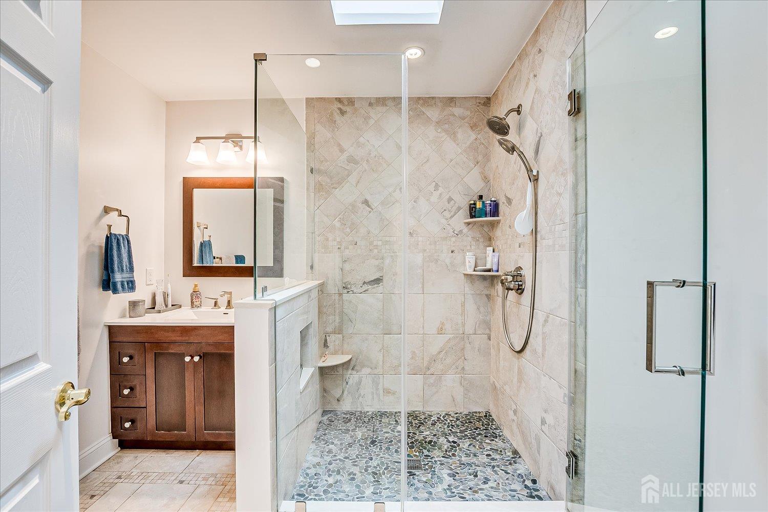 4805 Stonehedge Road Edison, NJ 08820 - Photo 26 of 41 a bathroom with a granite countertop shower a sink and a mirror
