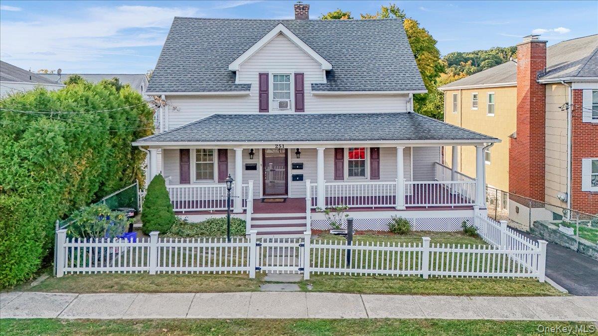 a front view of a house with a garden and plants