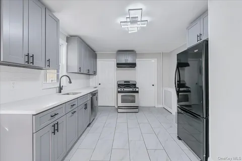 a kitchen with stainless steel appliances a refrigerator sink and cabinets
