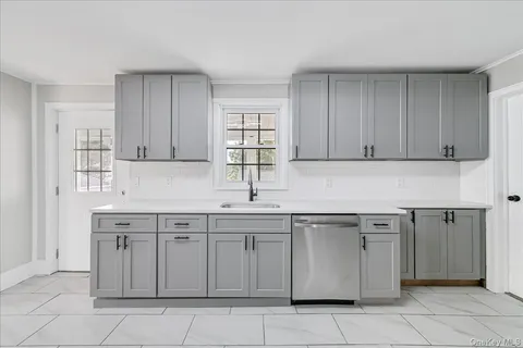 a kitchen with a sink and cabinets