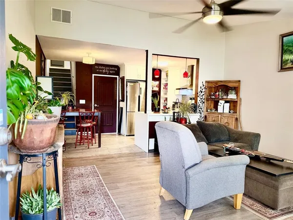 a living room with furniture and a potted plant