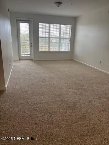 a kitchen with granite countertop a stove a sink and a refrigerator