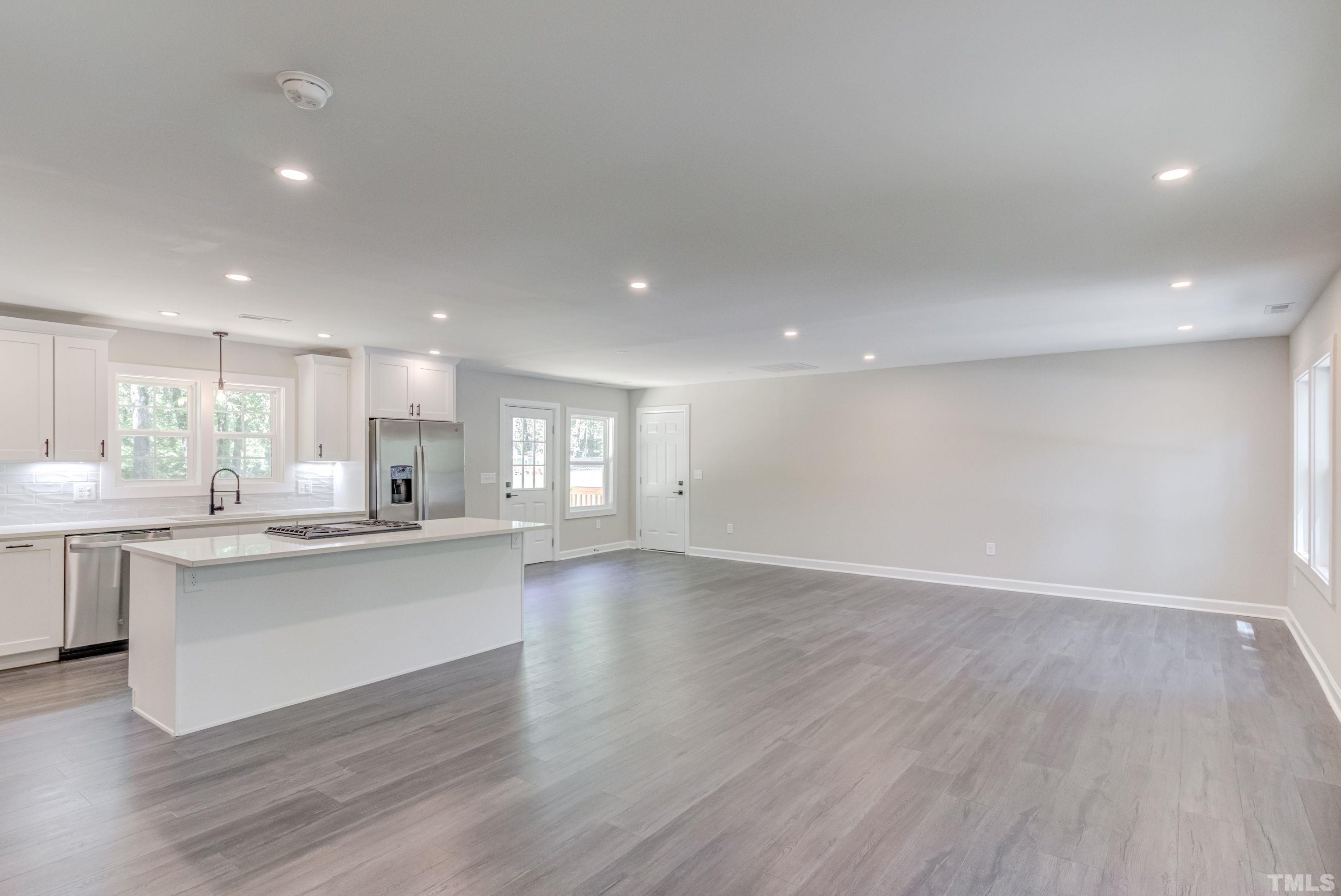 1321 Sedwick Road Durham, NC 27713 - Photo 5 of 27 a view of a kitchen with a sink and dishwasher a oven with wooden floor