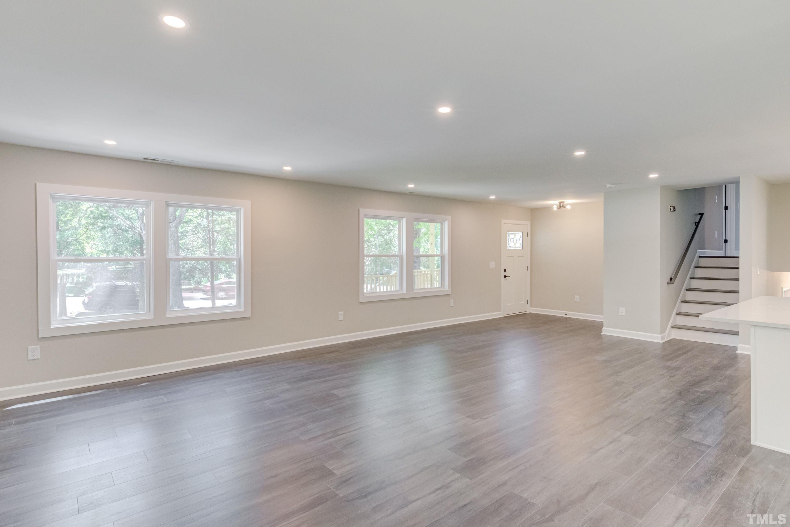 1321 Sedwick Road Durham, NC 27713 - Photo 6 of 27 an empty room with wooden floor and windows