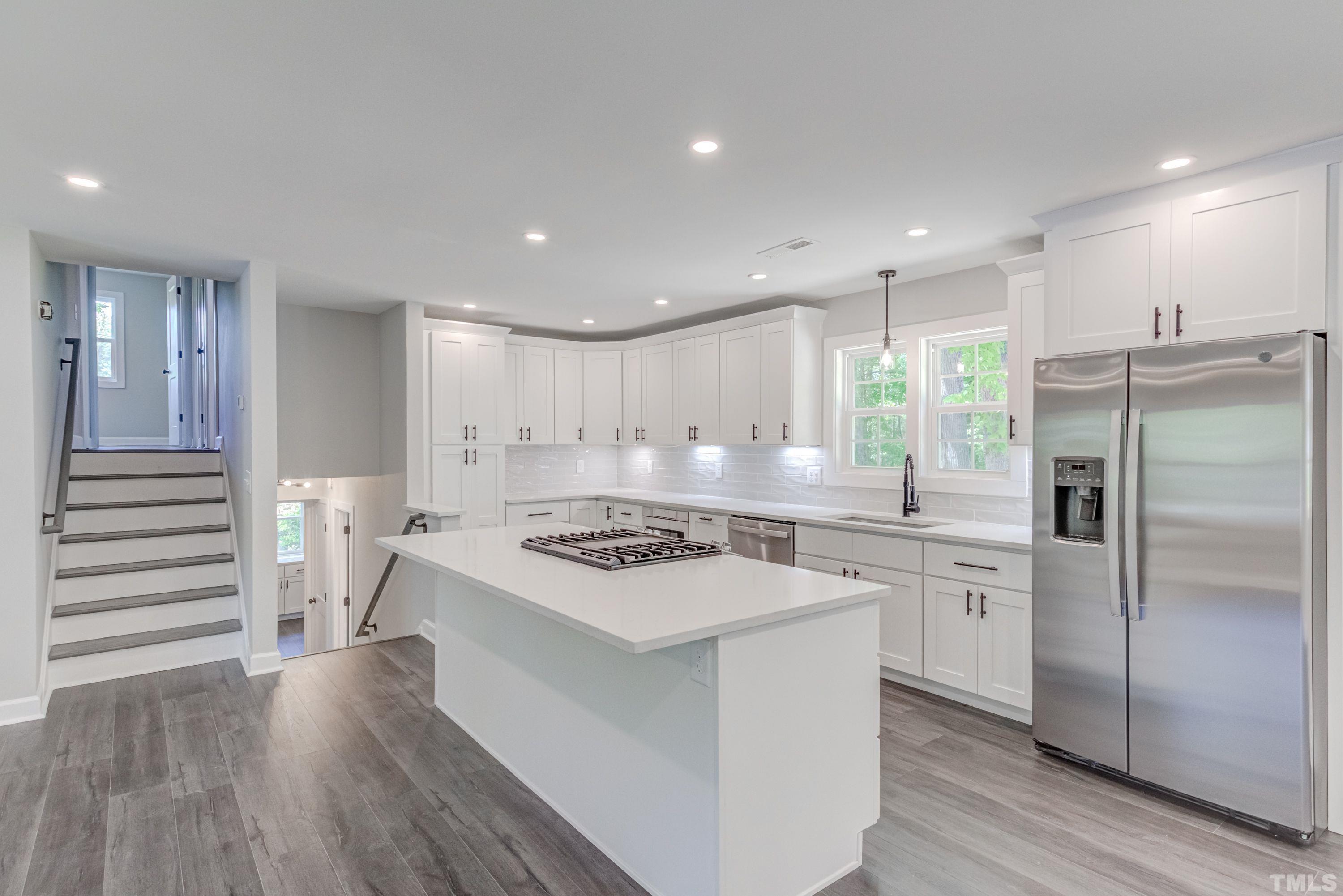 1321 Sedwick Road Durham, NC 27713 - Photo 8 of 27 a kitchen with a stove a sink and a refrigerator