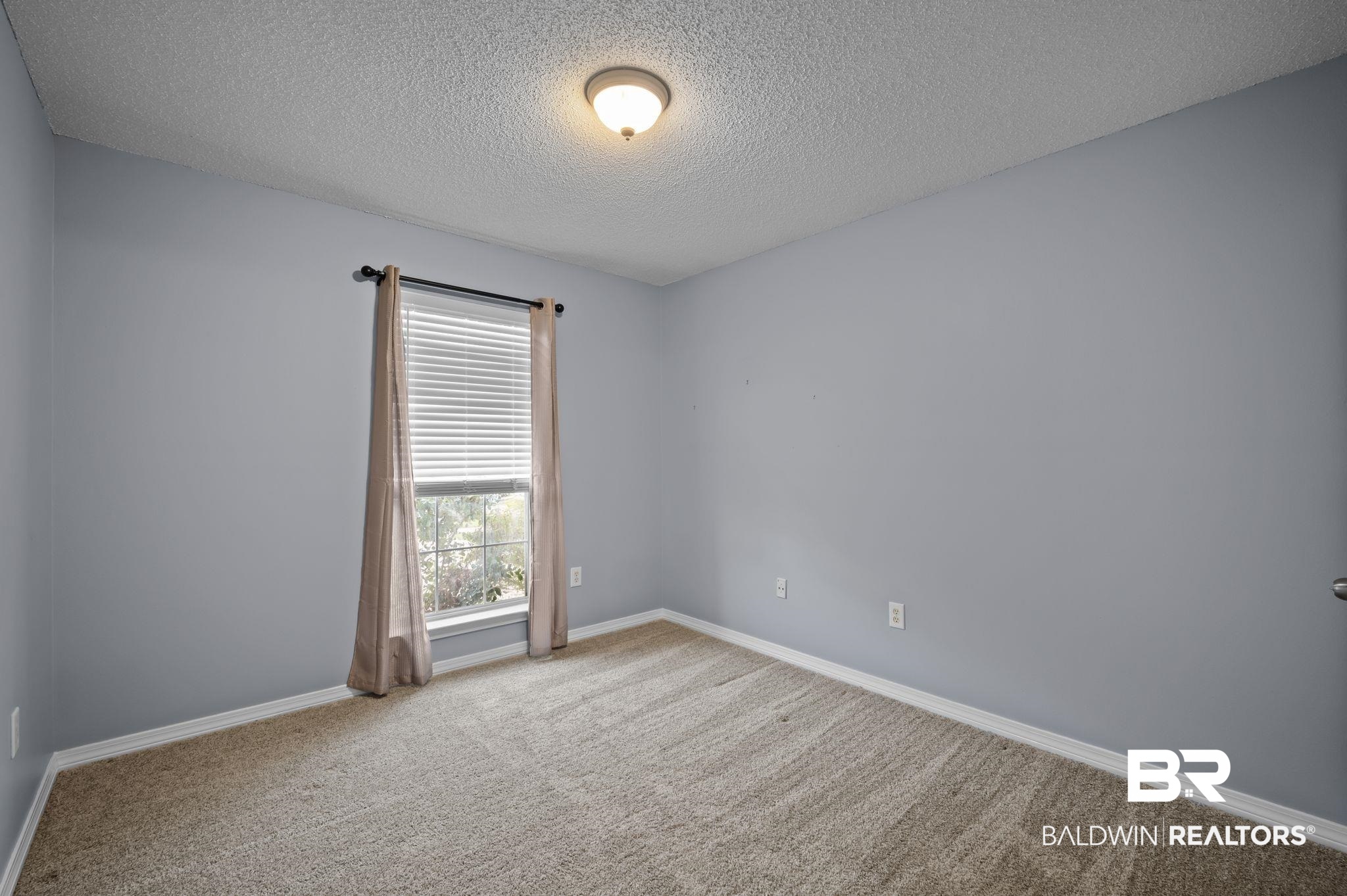 8901 Fall Court Mobile, AL 36695 - Photo 12 of 23 Carpeted empty room featuring a textured ceiling and baseboards
