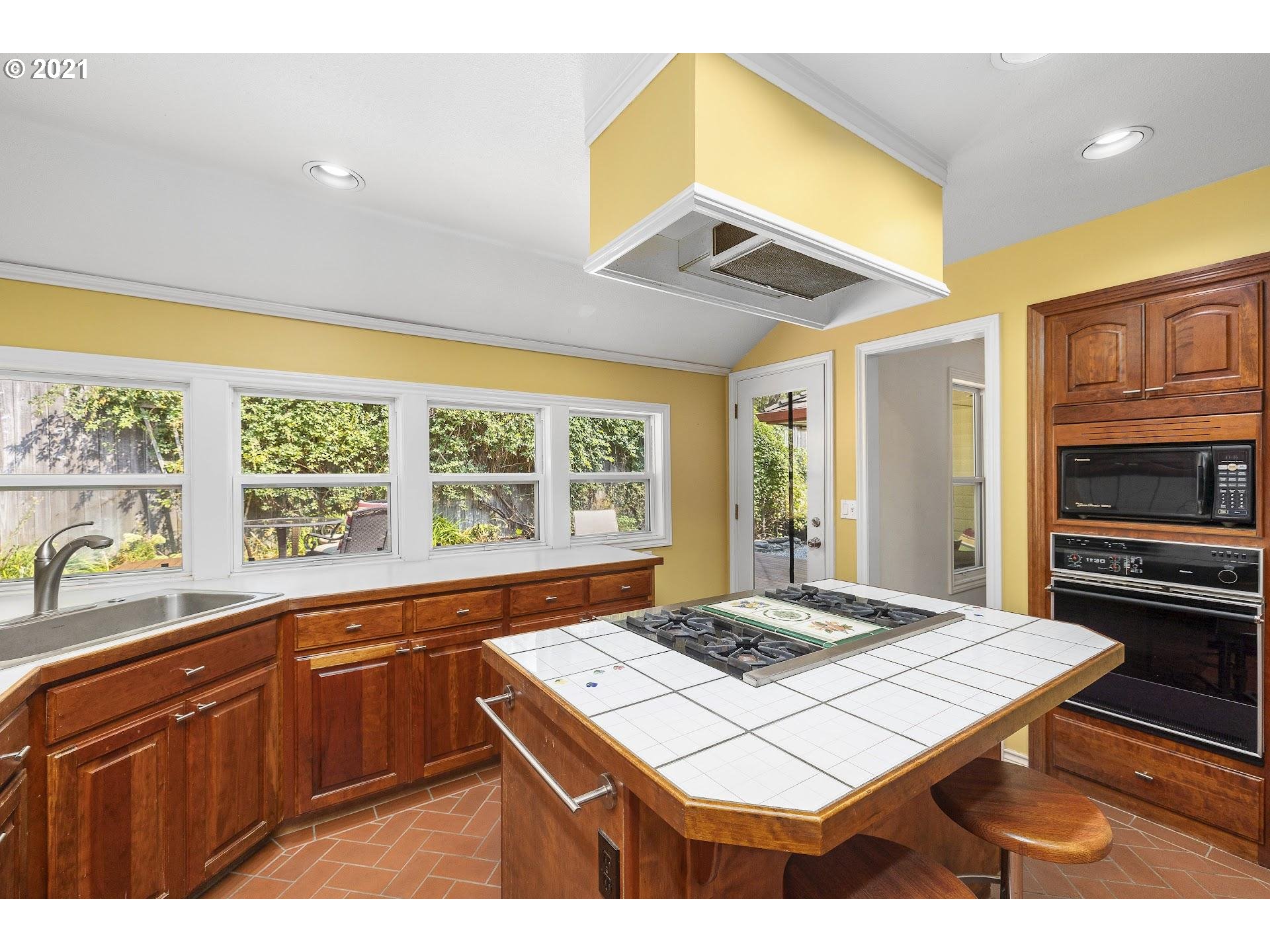 3916 Southwest Shattuck Road Portland, OR 97221 - Photo 11 of 28 a kitchen that has a stove and a table