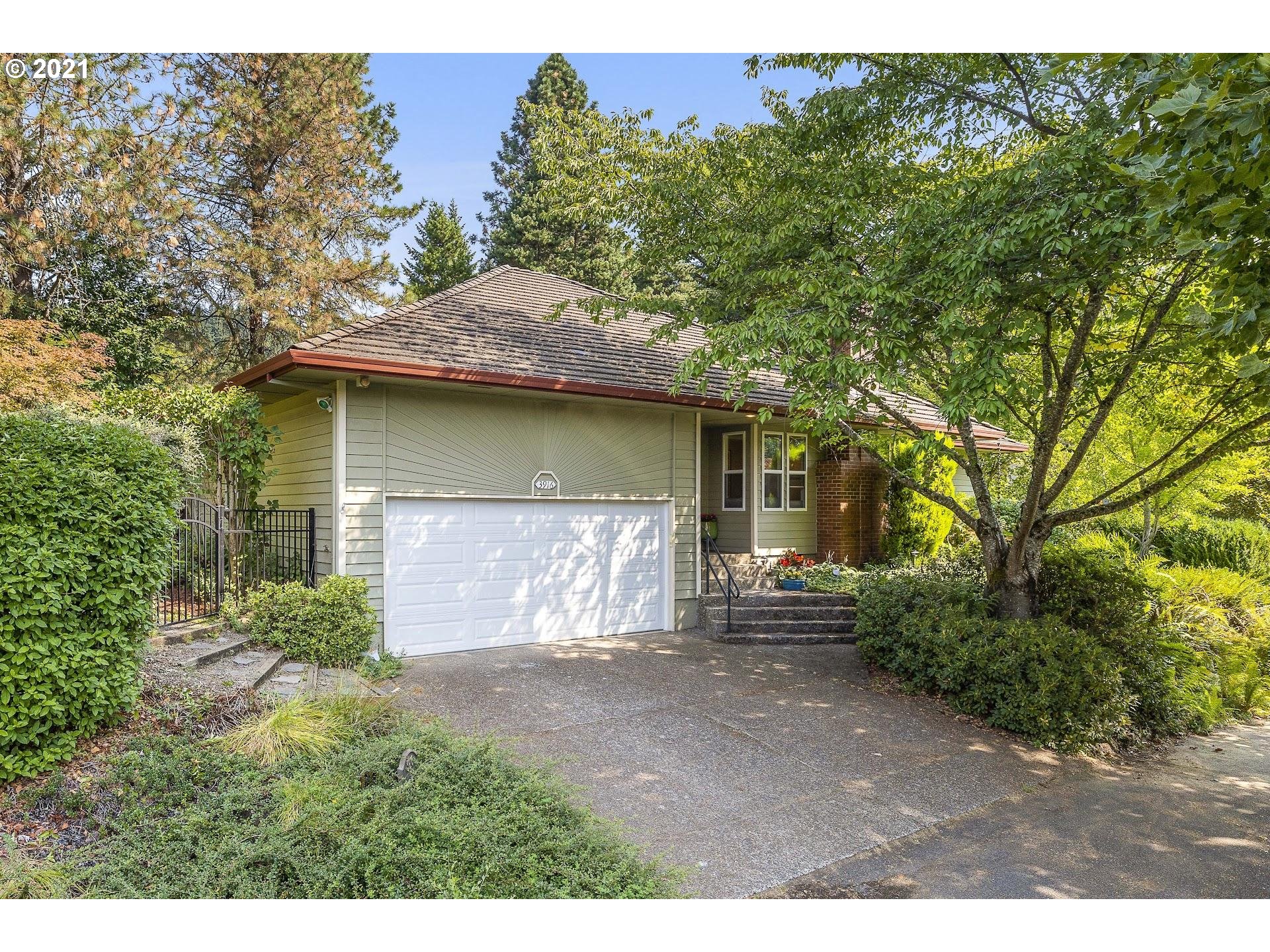 3916 Southwest Shattuck Road Portland, OR 97221 - Photo 14 of 28 a front view of a house with a garden