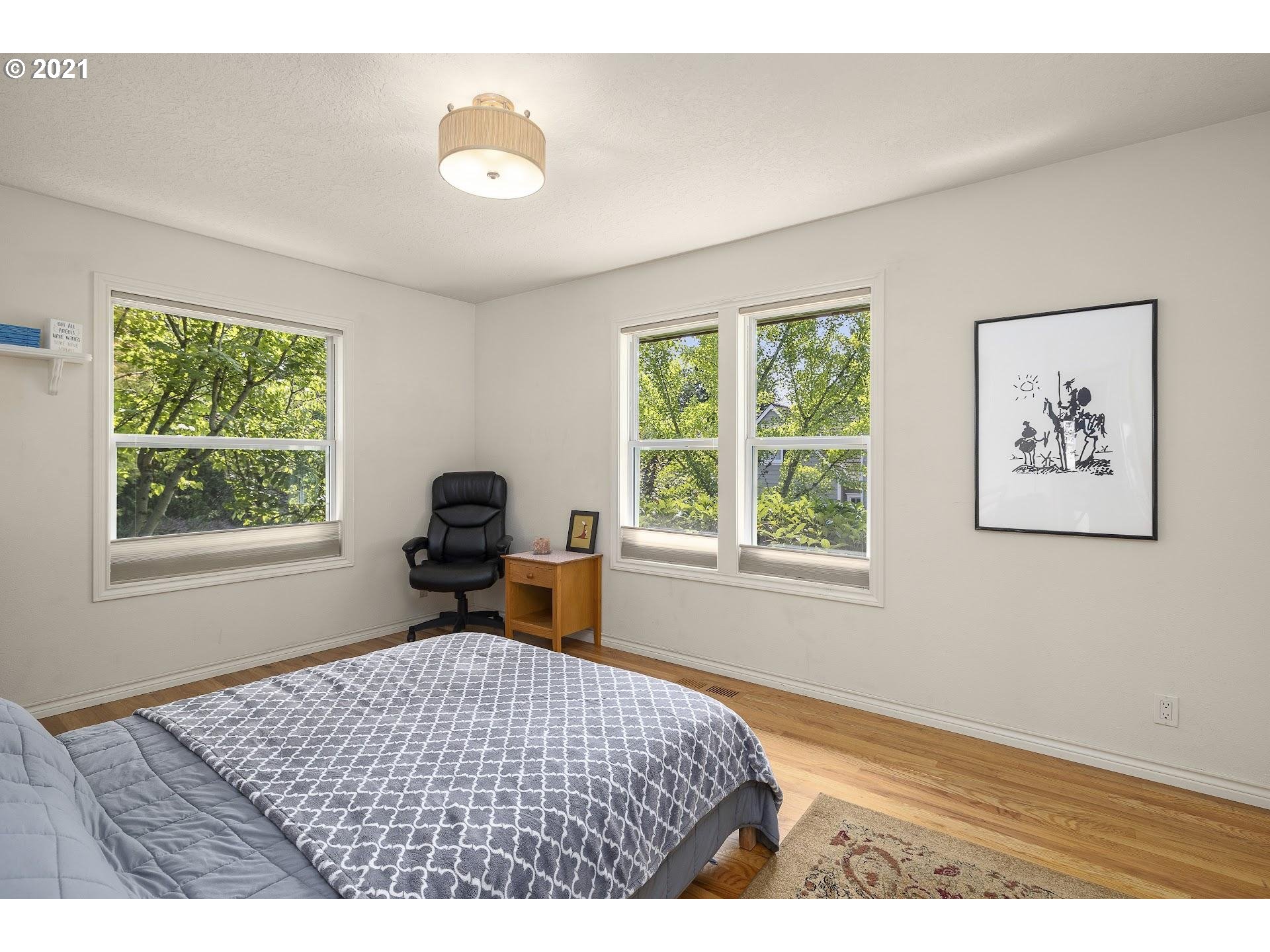 3916 Southwest Shattuck Road Portland, OR 97221 - Photo 18 of 28 a bedroom with a bed and a window