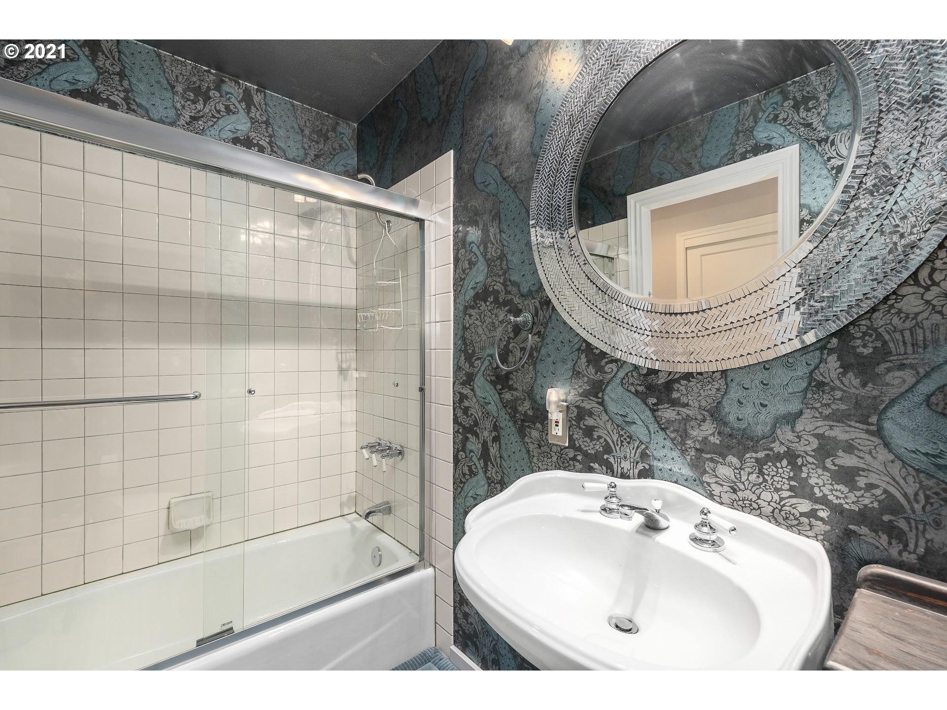 3916 Southwest Shattuck Road Portland, OR 97221 - Photo 19 of 28 a bathroom with a sink and a mirror