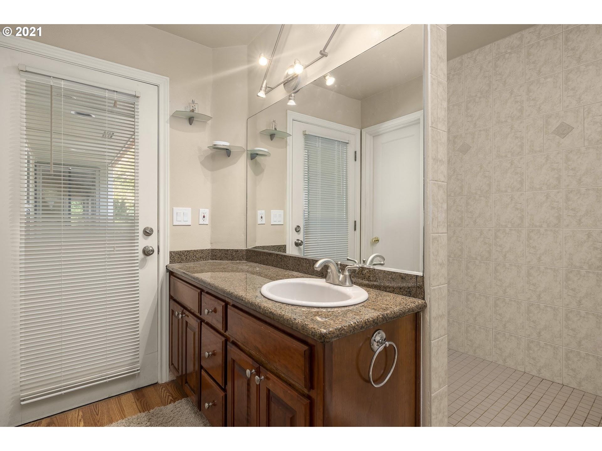3916 Southwest Shattuck Road Portland, OR 97221 - Photo 20 of 28 a bathroom with a sink and a mirror