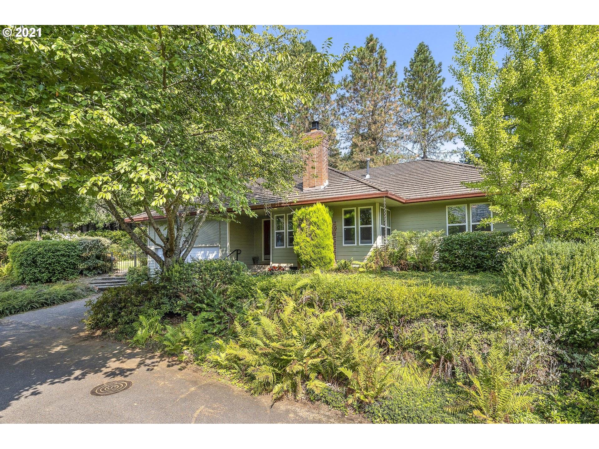 3916 Southwest Shattuck Road Portland, OR 97221 - Photo 3 of 28 a front view of a house with a yard