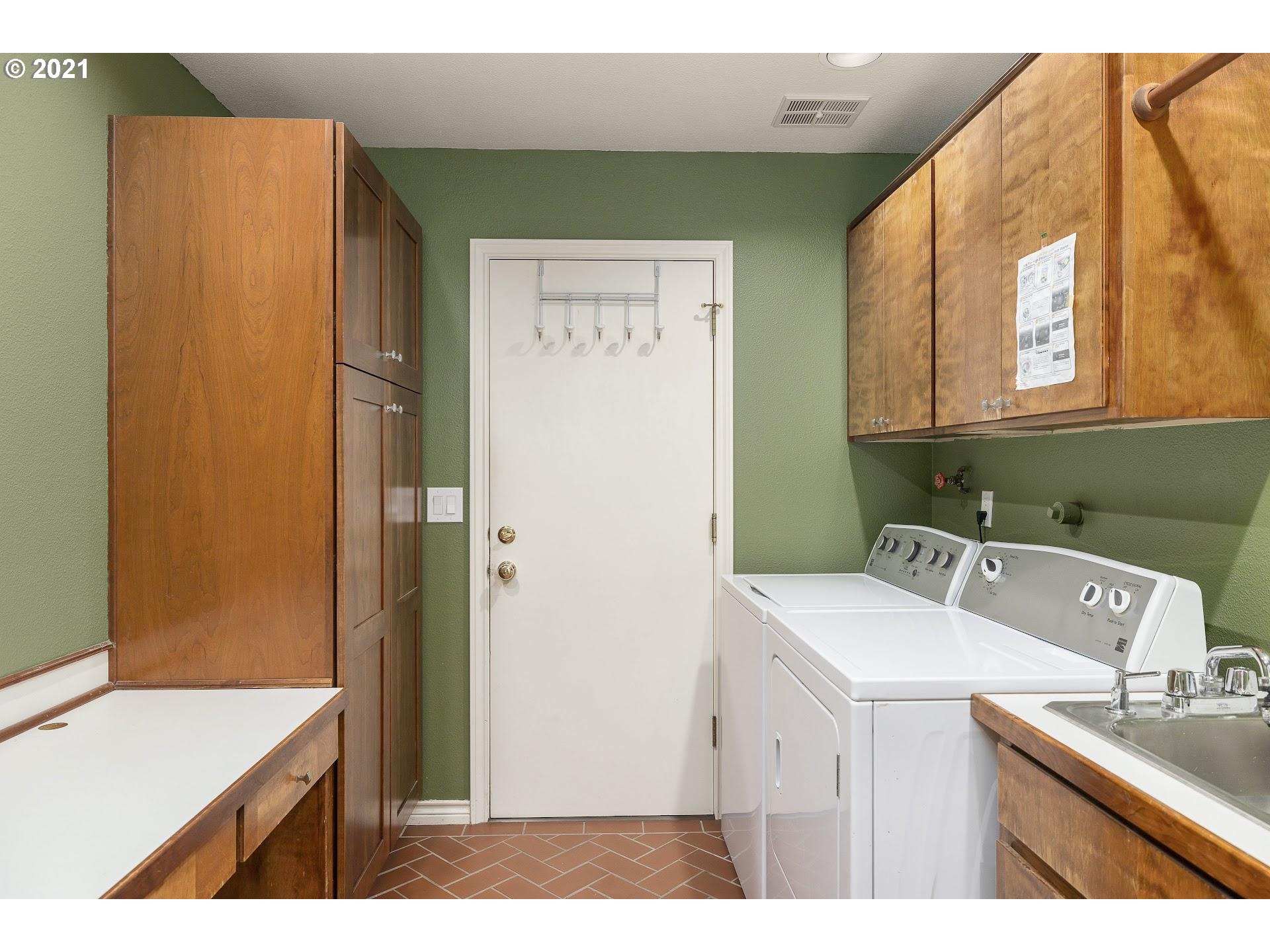 3916 Southwest Shattuck Road Portland, OR 97221 - Photo 26 of 28 a bathroom with a sink a mirror and a toilet