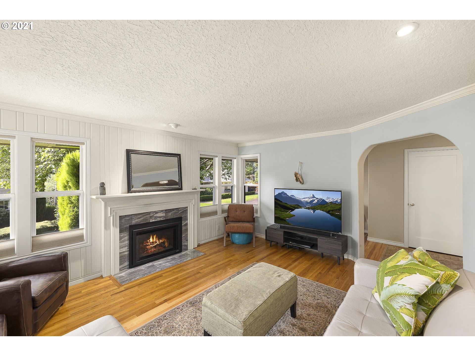 3916 Southwest Shattuck Road Portland, OR 97221 - Photo 6 of 28 a living room with furniture and a fireplace
