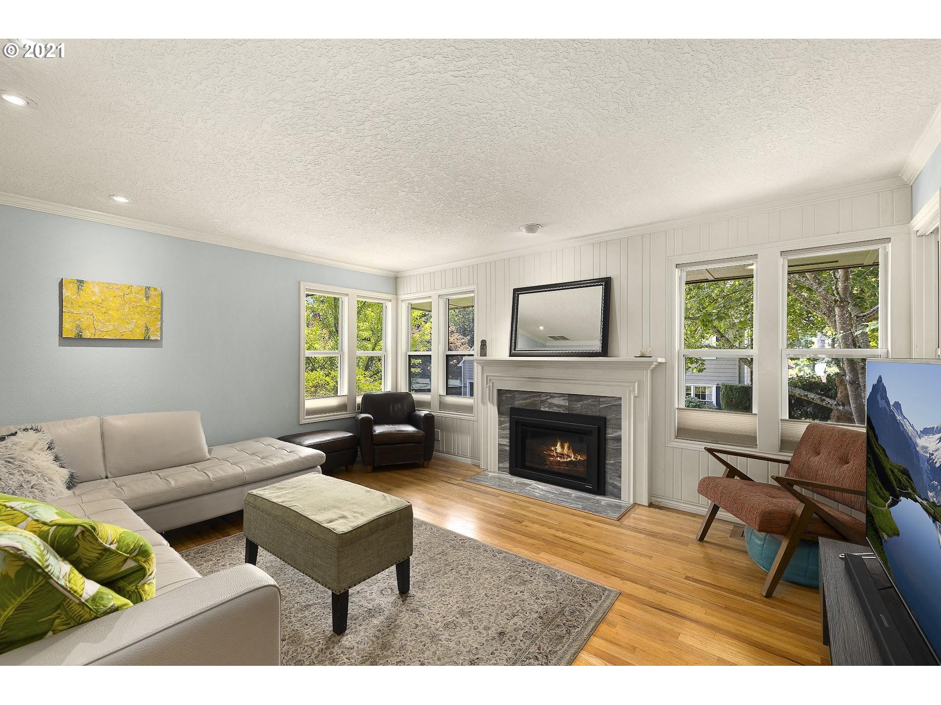 3916 Southwest Shattuck Road Portland, OR 97221 - Photo 7 of 28 a living room with furniture and a fireplace