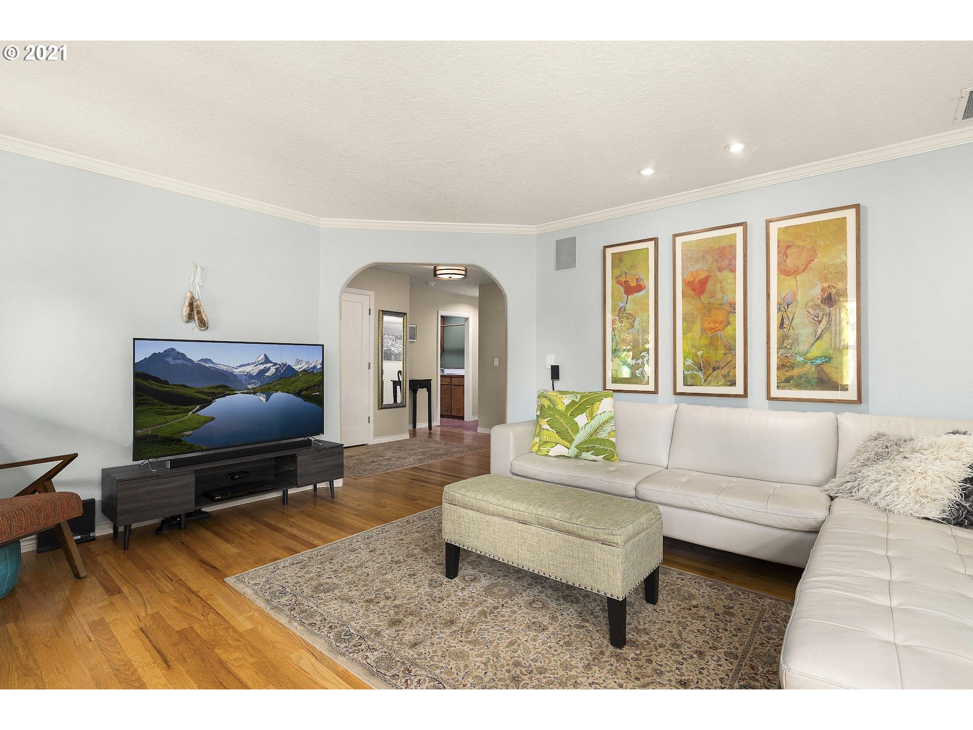 3916 Southwest Shattuck Road Portland, OR 97221 - Photo 8 of 28 a living room with furniture and a flat screen tv