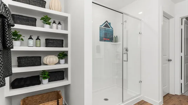 a kitchen with white cabinets and black appliances
